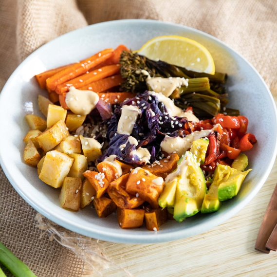 A bowl containing an assortment of chopped healthy vegetables. 