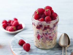 Raspberry and Yoghurt Bircher Muesli served in a glass.