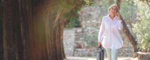 Woman walking with briefcase on phone