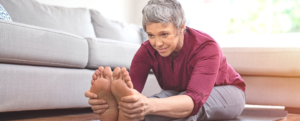Woman stretching on living room floor